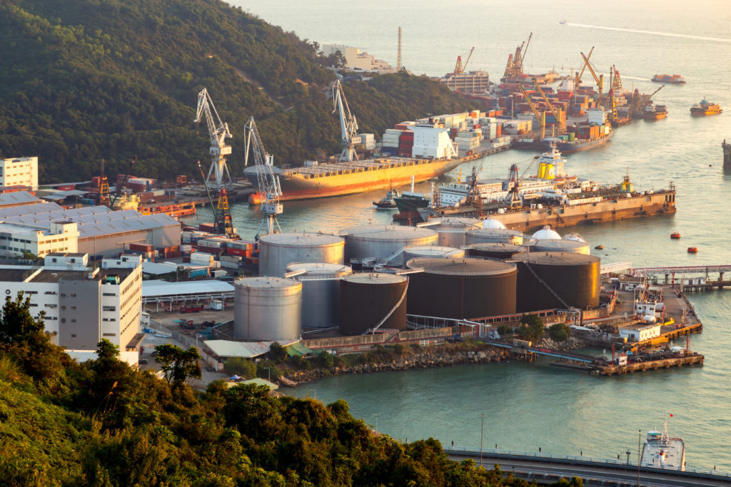 oil refinery plant in the port area for the chemical industry with various metal pipes and storage tanks.